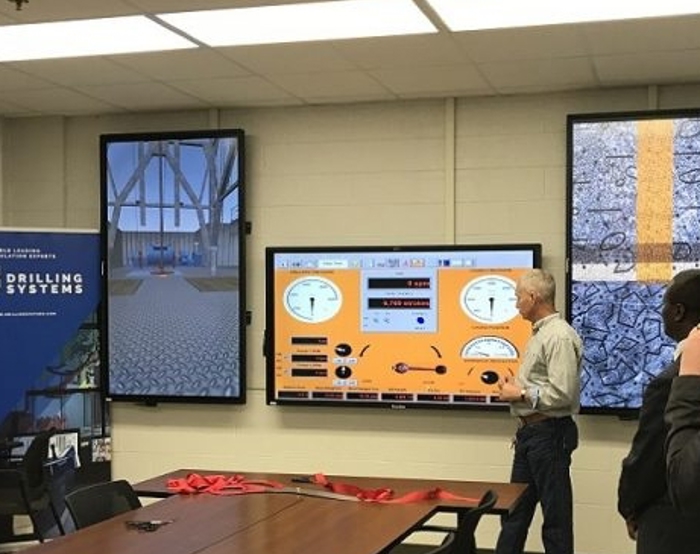 Three men observe multiple digital displays featuring industrial drilling systems in a control room setting. A conference table with red ribbons is in the foreground.