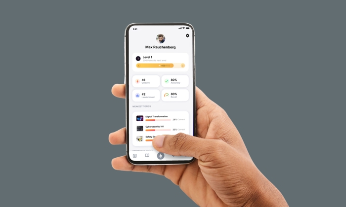 A person holds a smartphone displaying a profile screen for an app showing user statistics, such as level, progress in percent, and recent topics.